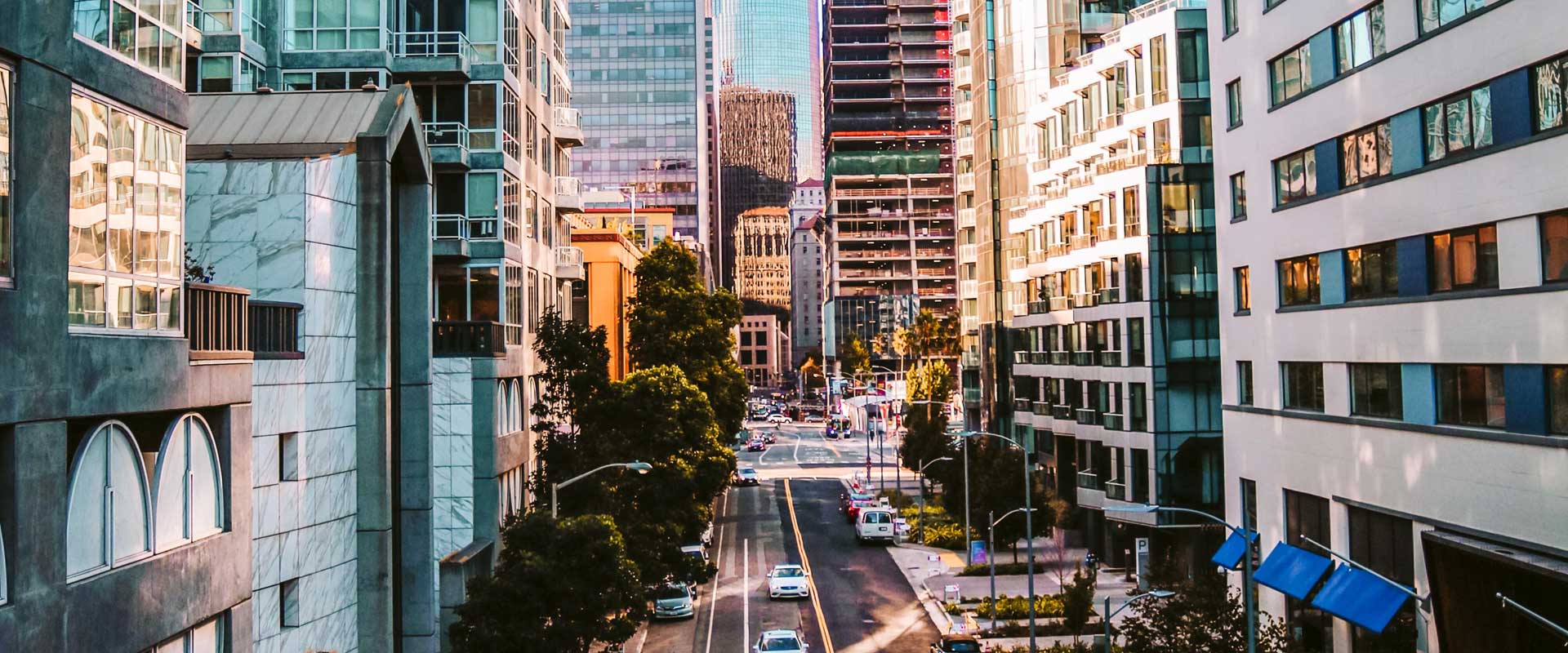 A busy downtown street lined with skyscrapers and office buildings.